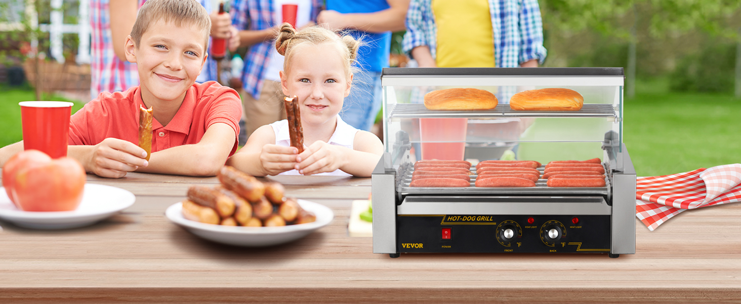 kids at a picnic with VEVOR hot dog roller grilling hot dogs and buns on a wooden table with food.